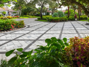 a paver walkway with flowers and trees