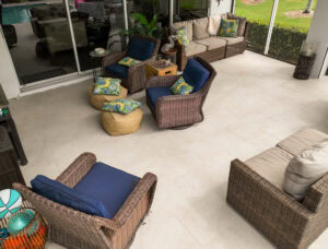 a patio with wicker furniture and staggered running pattern porcelain tile