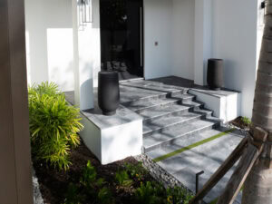 a custom travertine stairs leading to a house
