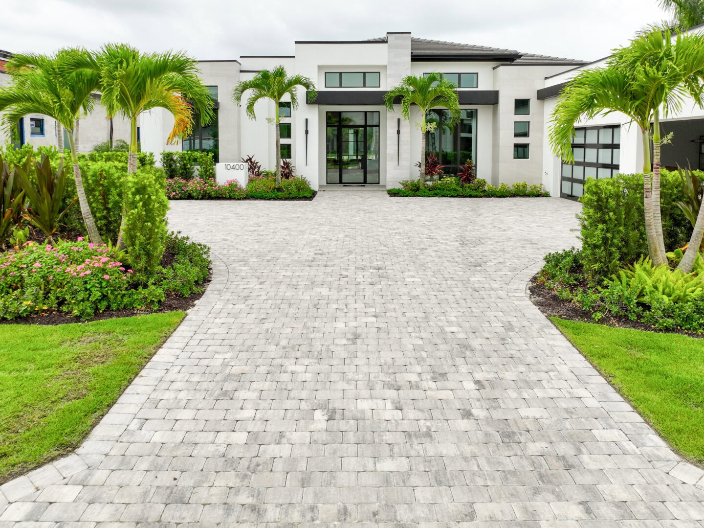 Modern house with landscaped driveway by accurate pavers