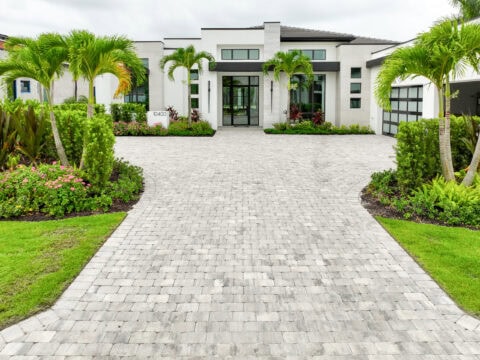 Modern house with landscaped driveway by accurate pavers