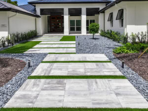 Modern pathway with grass and stones, paved walkway installation by accurate pavers