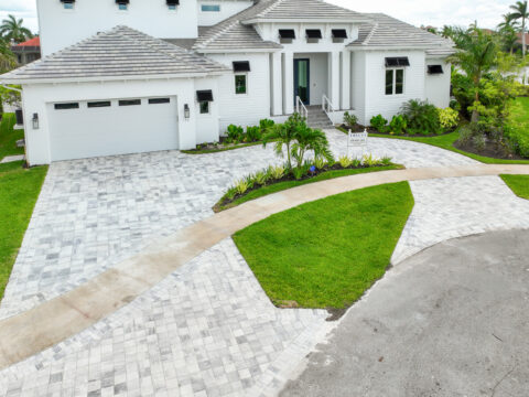Modern house with landscaped paved driveway by accurate pavers