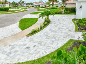 Curved paved driveway with lush landscaping