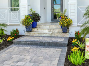 Elegant entrance with vibrant flowers - paved walkway