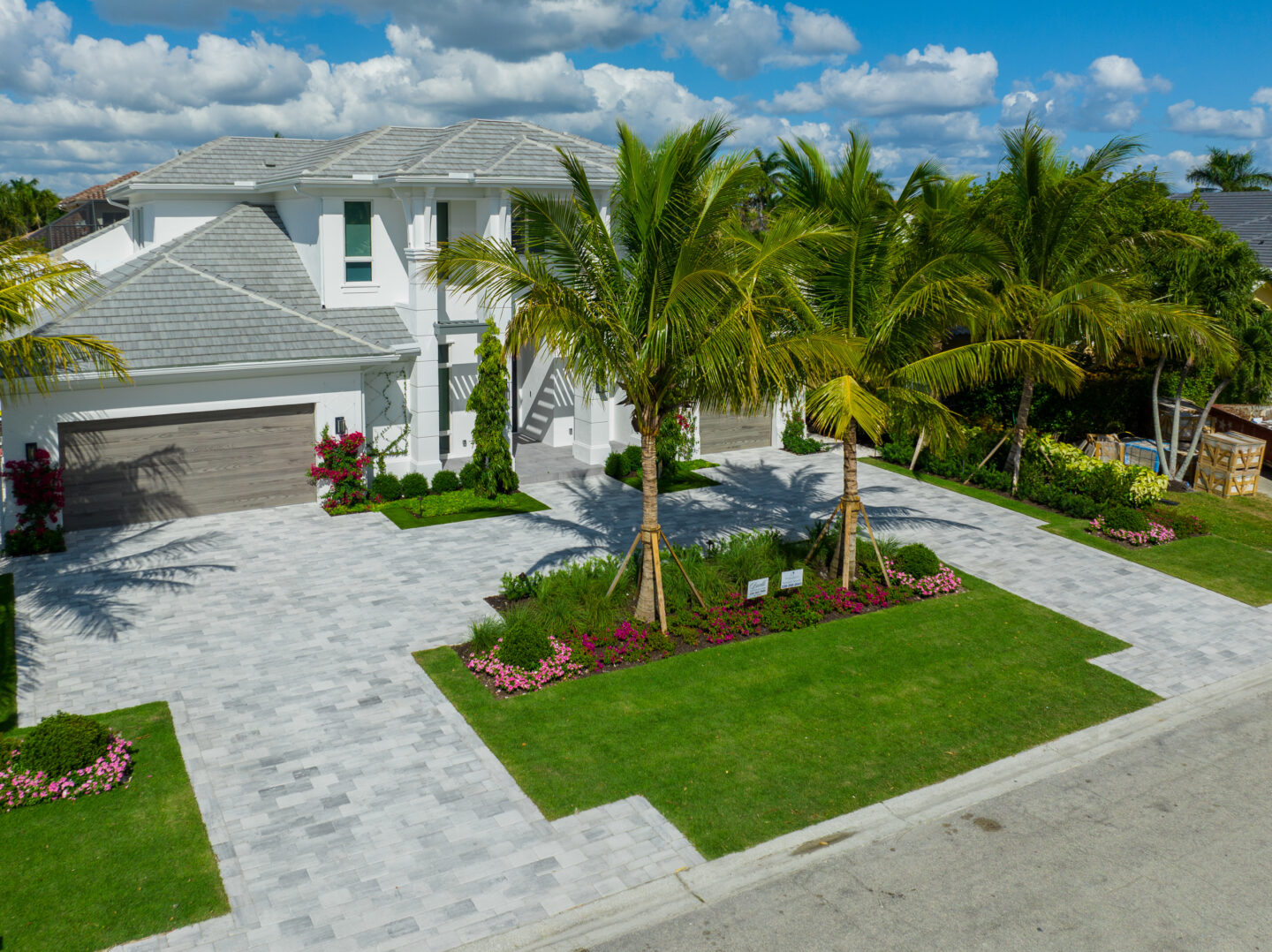 Modern house with paved driveway by accurate pavers